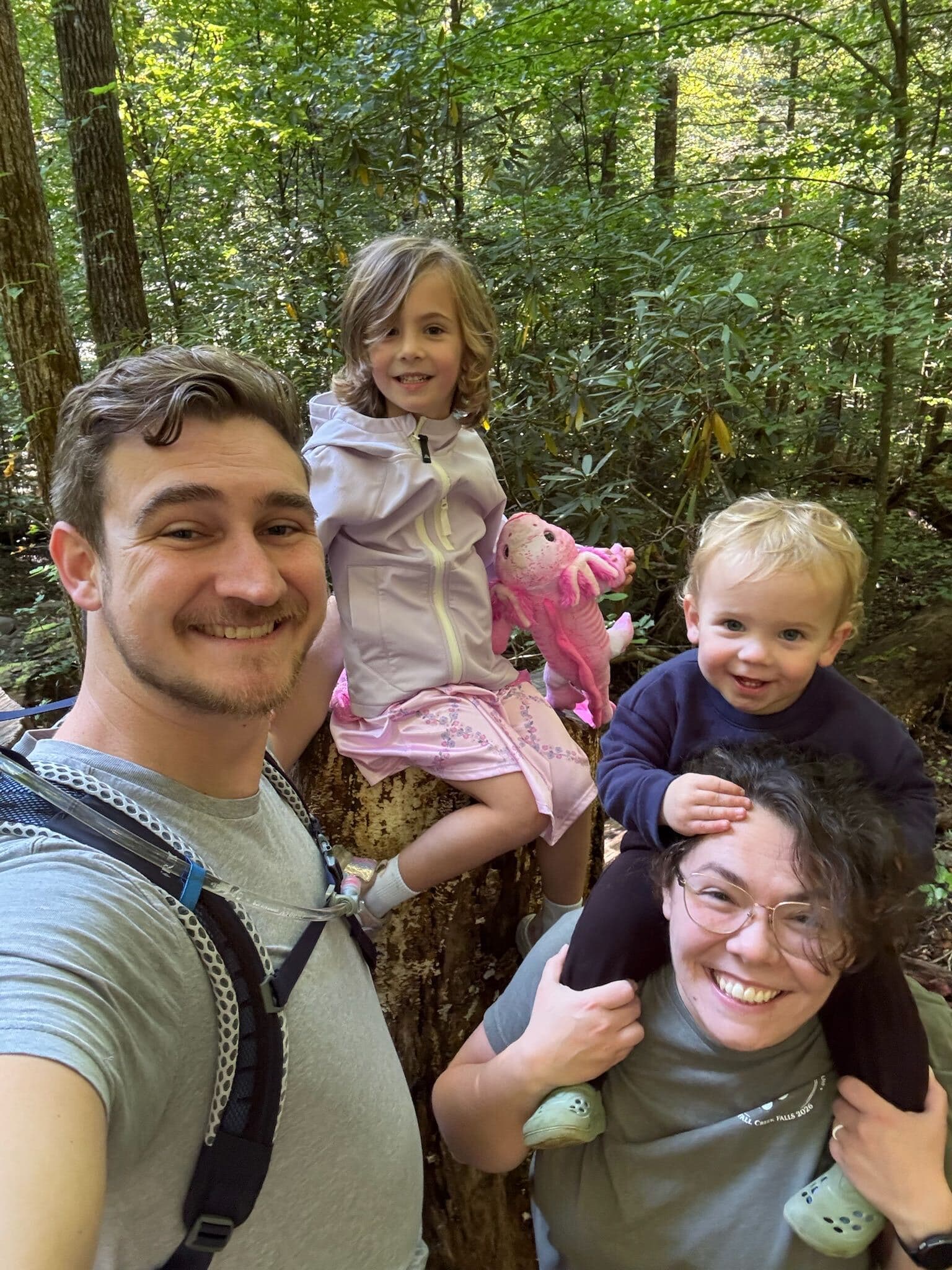 Brandon Peterson and family on a wooded trail